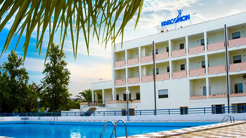 Narconon Gabbiano rehabilitation center in Italy with swimming pool, sports fields, fitness facilities, and peaceful gardens for addiction recovery